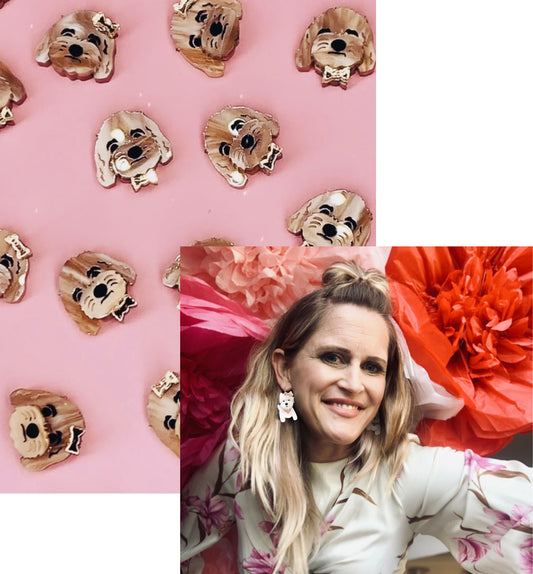 Acrylic dog earrings on a pink background and Blinghound founder wearing statement earring