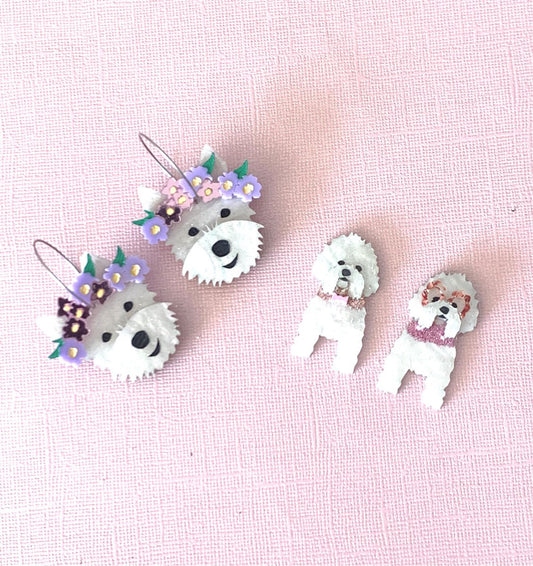 Acrylic dog earrings on pink background