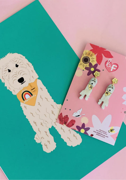 Pair of acrylic dog earrings and dog illustration pink background