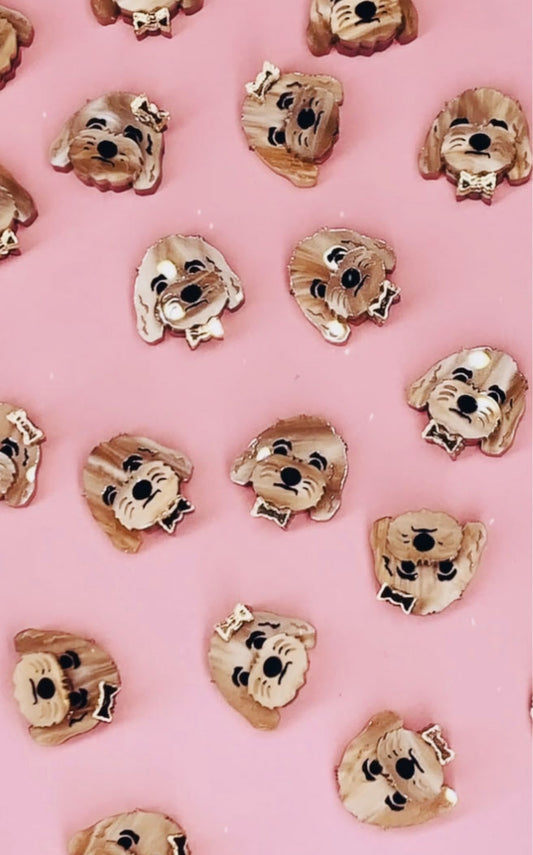 Acrylic dog earrings on pink background